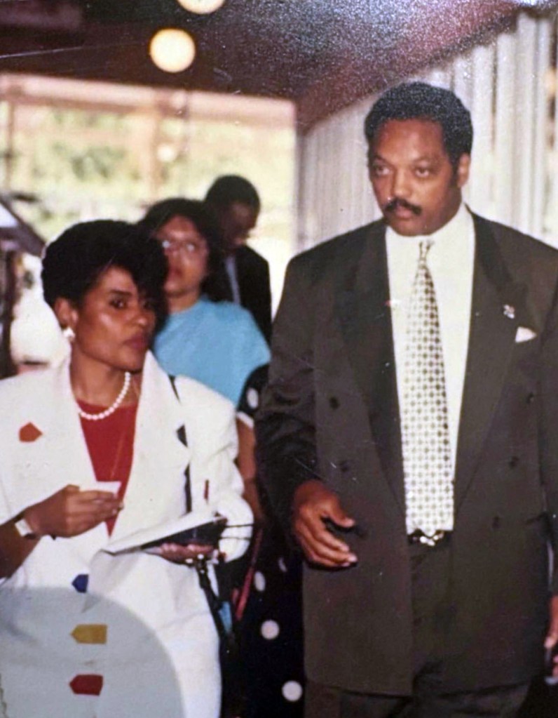 Rev. Jesse Jackson walking beside Minyon Moore in Texas in 1988 during his presidential campaign.