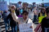 People protests against Immigration and Customs Enforcement as they march toward the South Texas Family Residential Center.