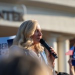 Spanberger speaks into a microphone in front of a crowd.