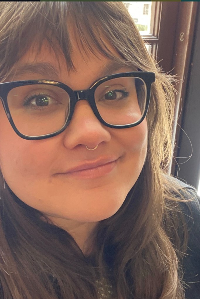 Closeup portrait of Mandi wearing glasses.