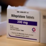 Mifepristone tablets sit on a table at a Planned Parenthood clinic.