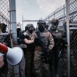 Federal agents stand guard during a protest against federal immigration enforcement raids at Delaney Hall Detention Facility in New Jersey.