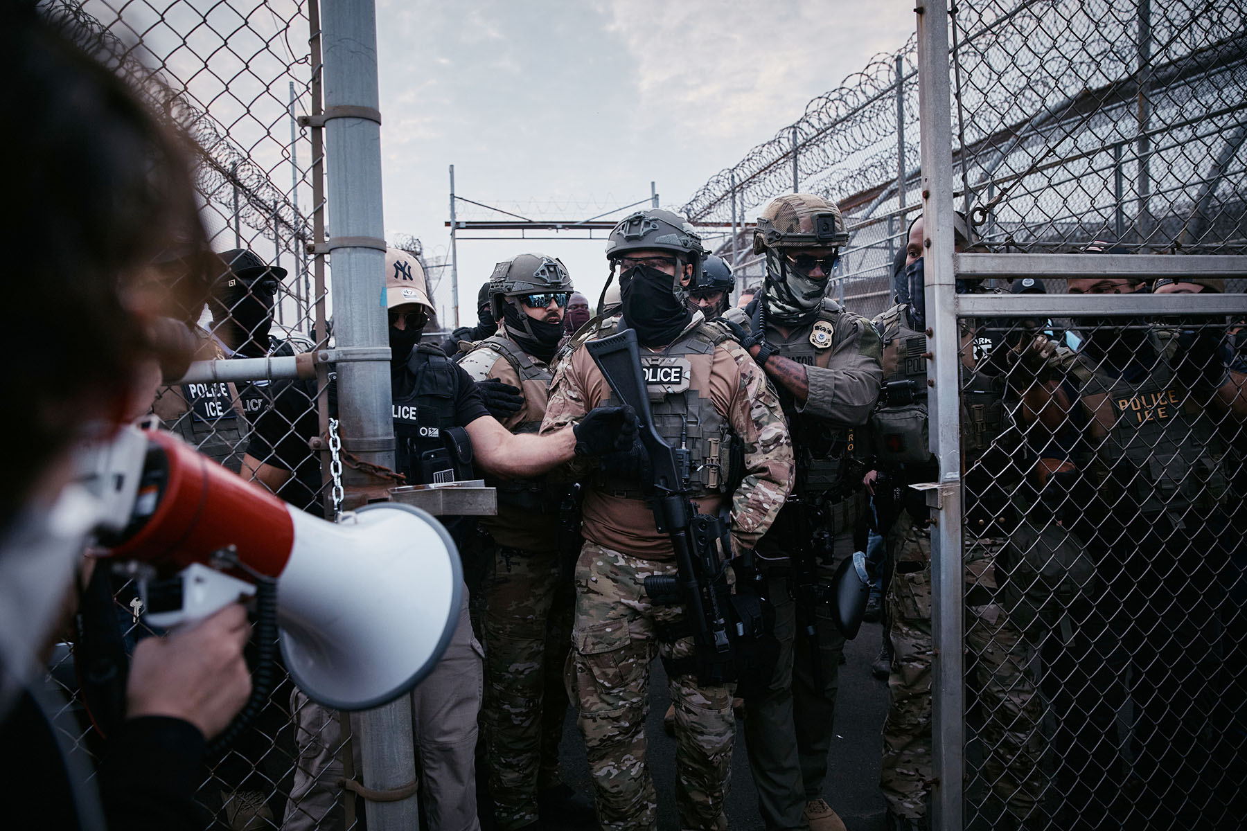 Federal agents stand guard during a protest against federal immigration enforcement raids at Delaney Hall Detention Facility in New Jersey.