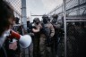 Federal agents stand guard during a protest against federal immigration enforcement raids at Delaney Hall Detention Facility in New Jersey.