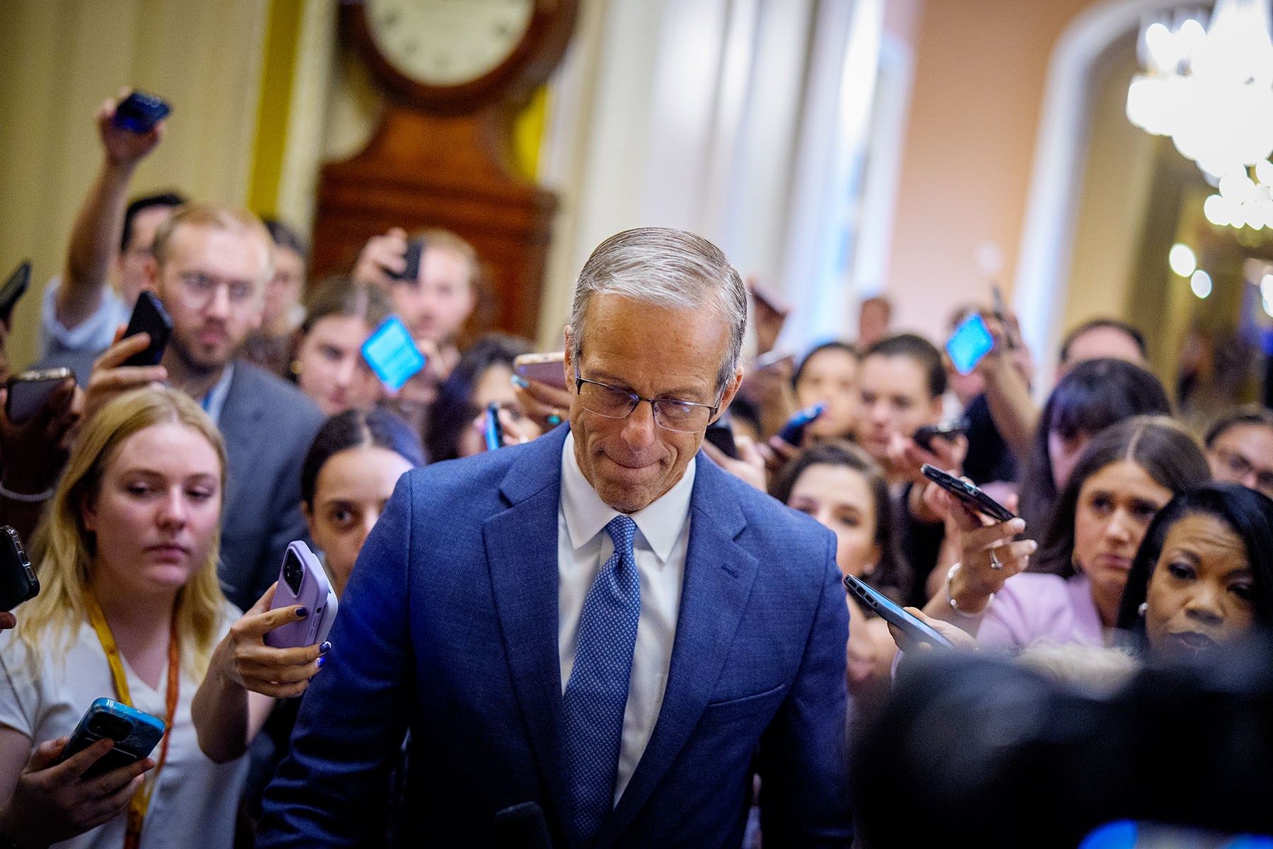 Senate Majority Leader John Thune walks toward the Senate floor at the Capitol Building.