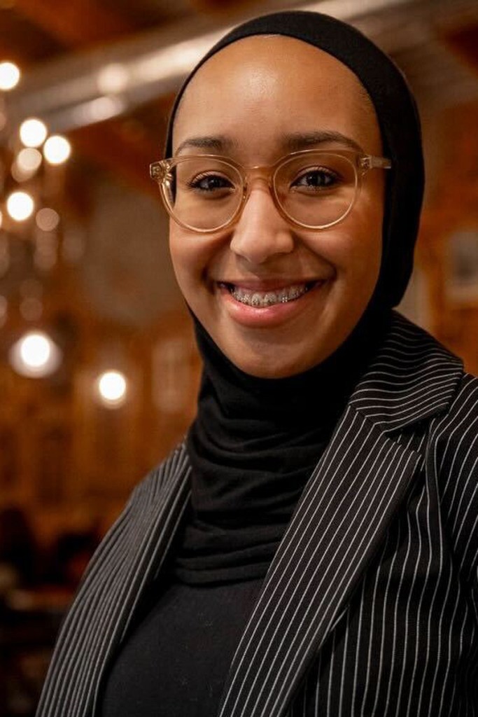 A woman smiles into the camera.