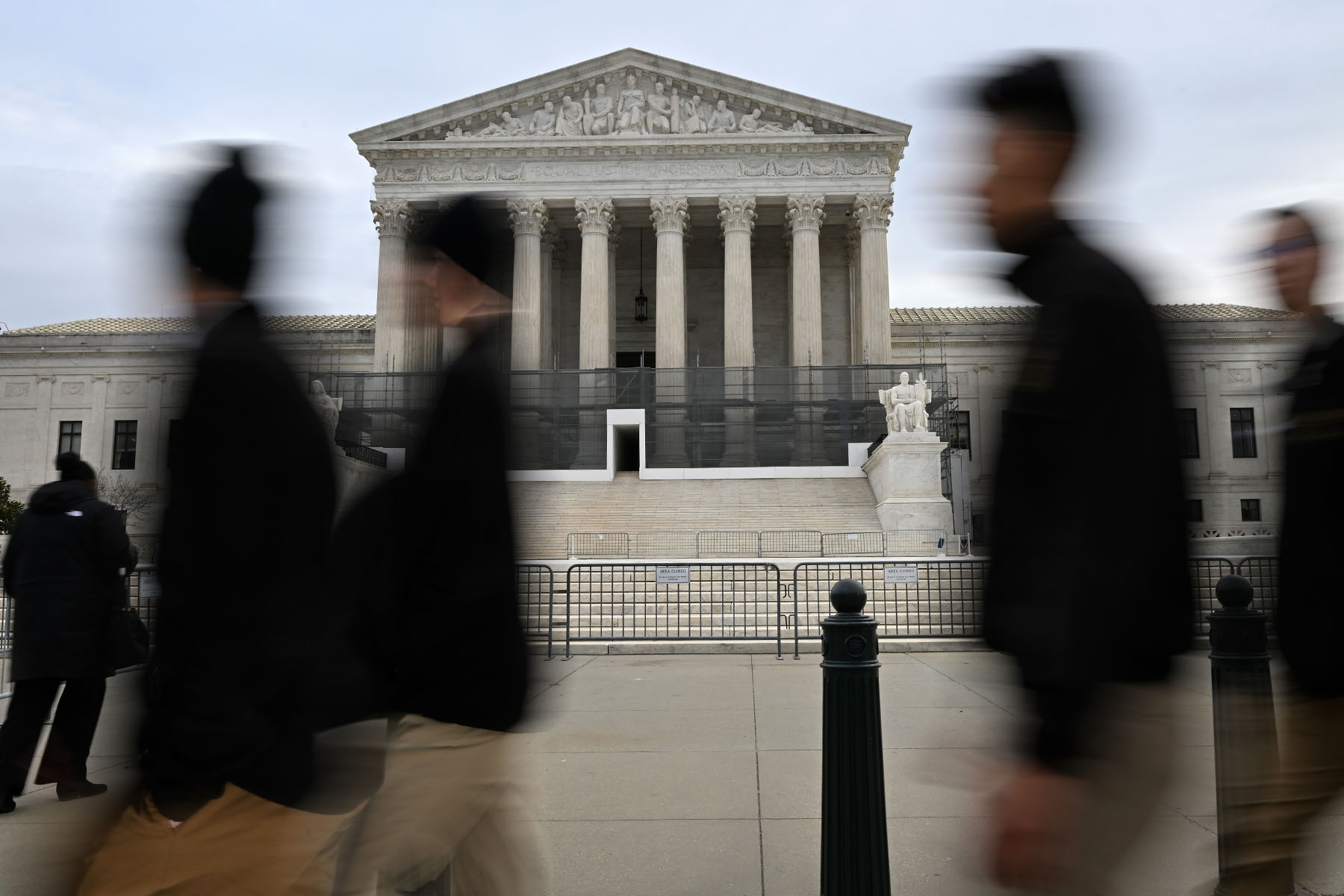 People walk by the Supreme Court of the United States.