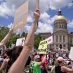 Activists rally outside the State Capitol in support of abortion rights.
