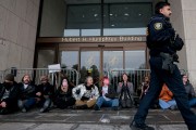 Protesters with Gender Liberation Movement and ACT UP block the entrance to the Department of Health and Human Services while protesting the Trump administration’s plan to cut federal funding to clinics providing care for transgender youth.