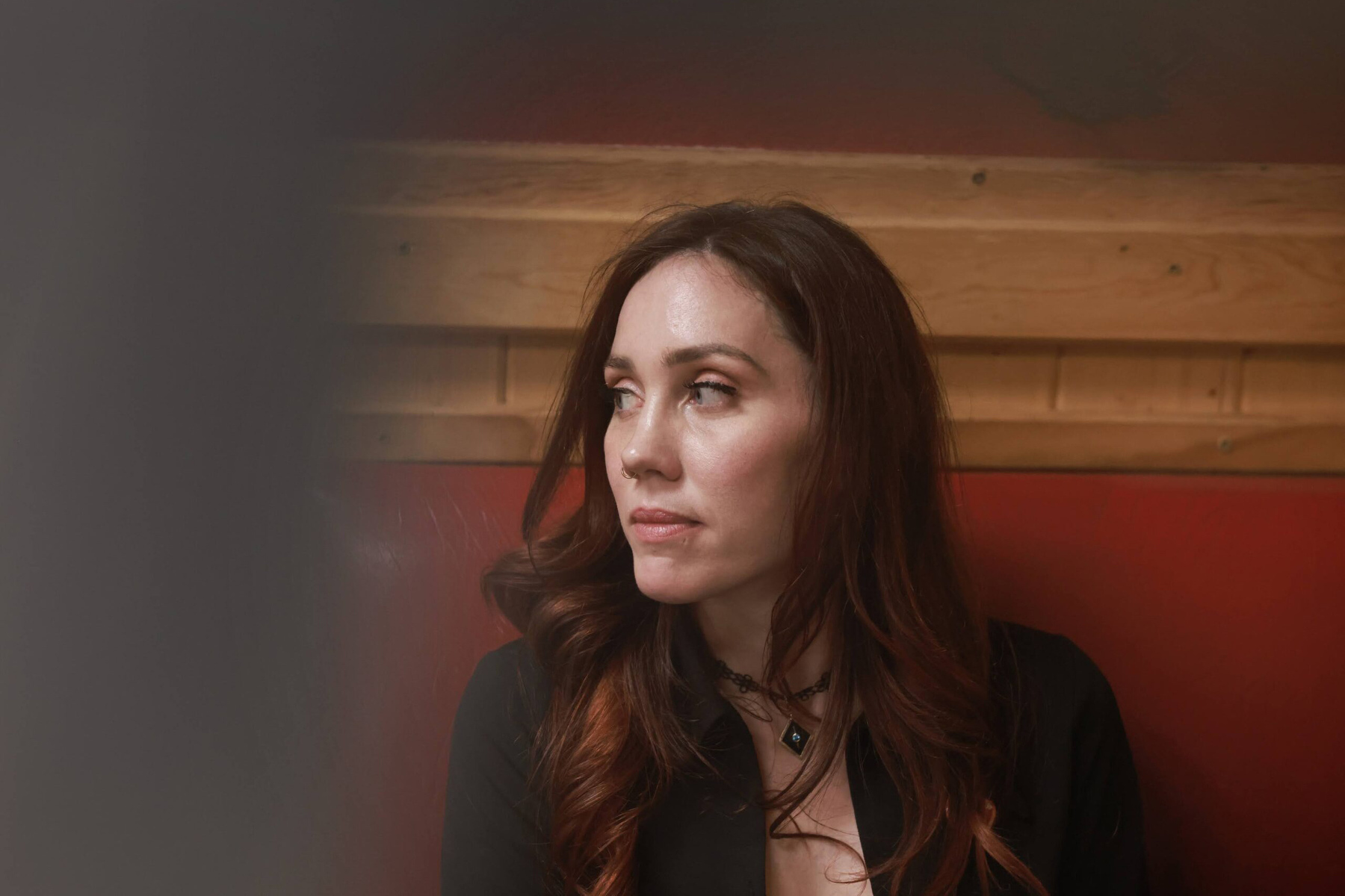 A woman looks to the side in a closeup portrait.