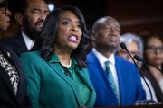 Rep. Terri Sewell speaks at a podium during a press conference, surrounded by other members of Congress.