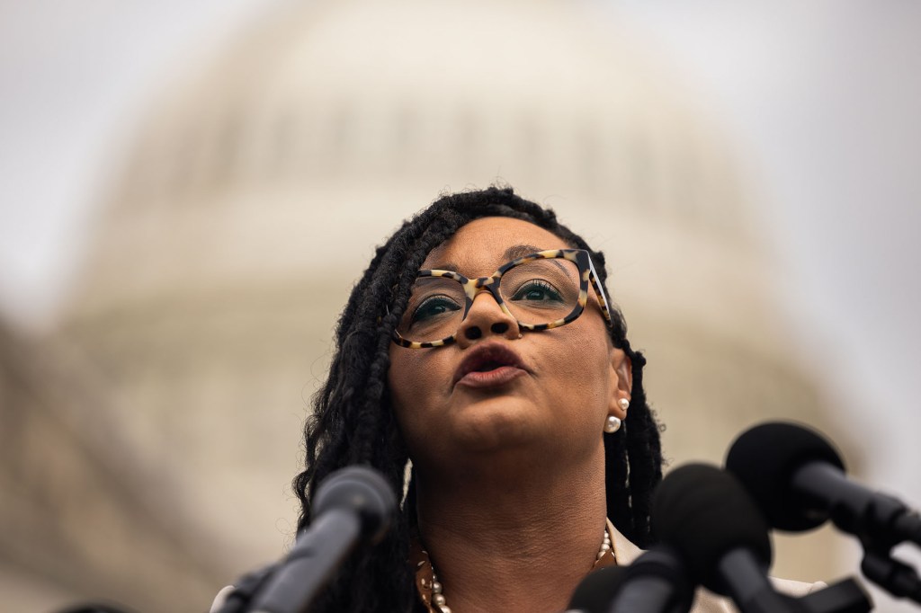 Rep. Nikema Williams speaks into microphones outside the Capitol.