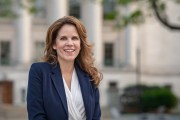 A portrait of the judge outside of a courthouse in a blazer.