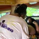 Woman treating a patient during a pregnancy checkup inside a mobile midwifery clinic.