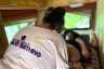 Woman treating a patient during a pregnancy checkup inside a mobile midwifery clinic.