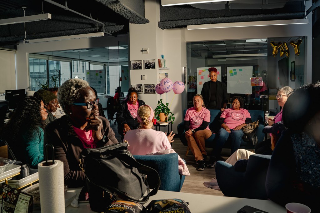 Allison Julien stands near a group of domestic workers during a meditation session at the National Domestic Workers Alliance headquarters.