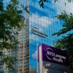 Exterior of NYU Langone Health’s main campus building framed by trees.