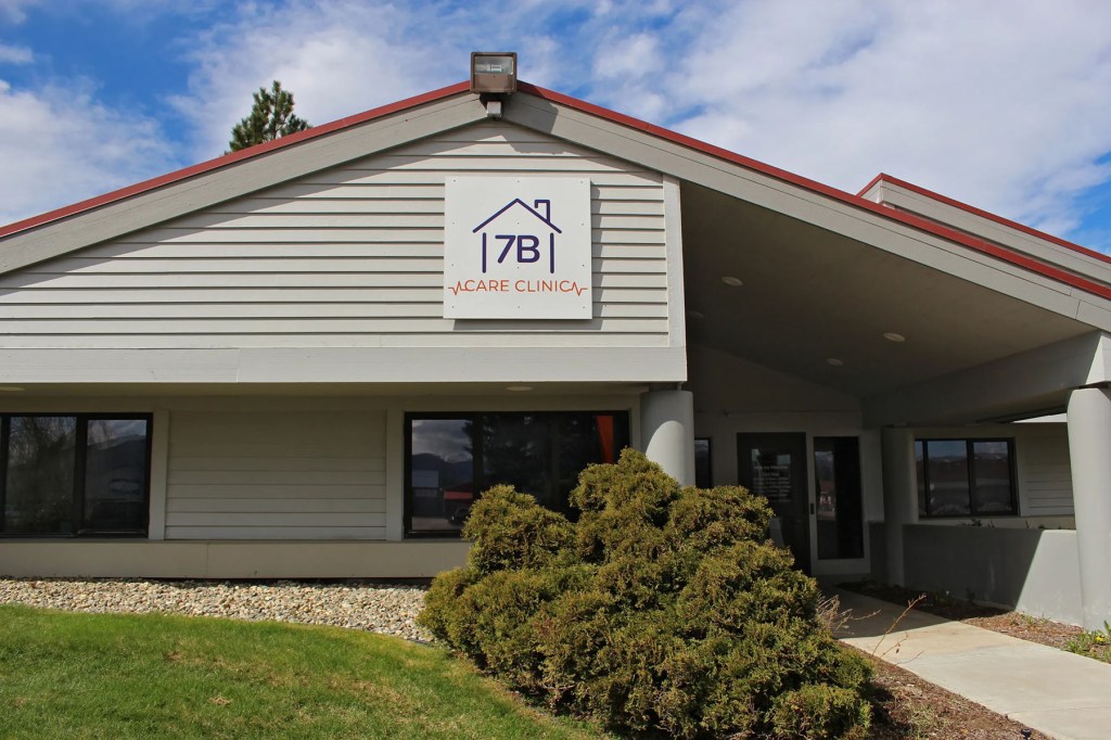 The exterior of 7B Care Clinic, with the clinic sign mounted above the entrance of a building.