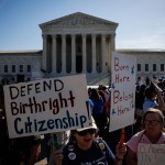 Protestors gather in front of the Supreme Court holding signs that read 