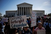 Protestors gather in front of the Supreme Court holding signs that read 