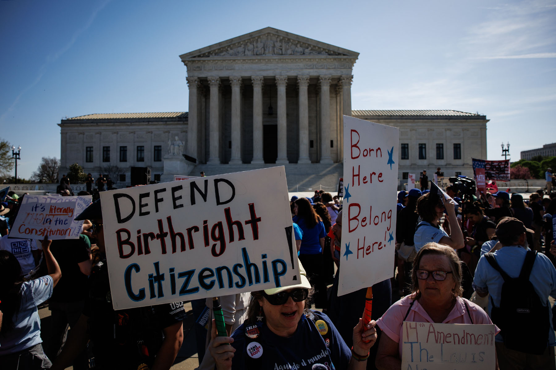 Protestors gather in front of the Supreme Court holding signs that read "DEFEND BIRTHRIGHT CITIZENSHIP" and "Born Here, Belong Here."