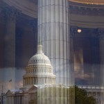 The Capitol dome is reflected over the interior of a building with tall marble columns.