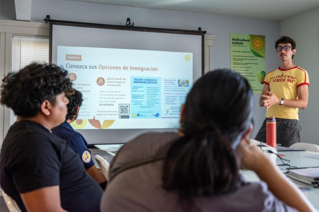 A small group of people gathered at a conference table at Multicultural Institute in Berkeley for a presentation on family preparedness plans