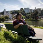 Woman sitting on a bench at Lake Merritt in Oakland, California