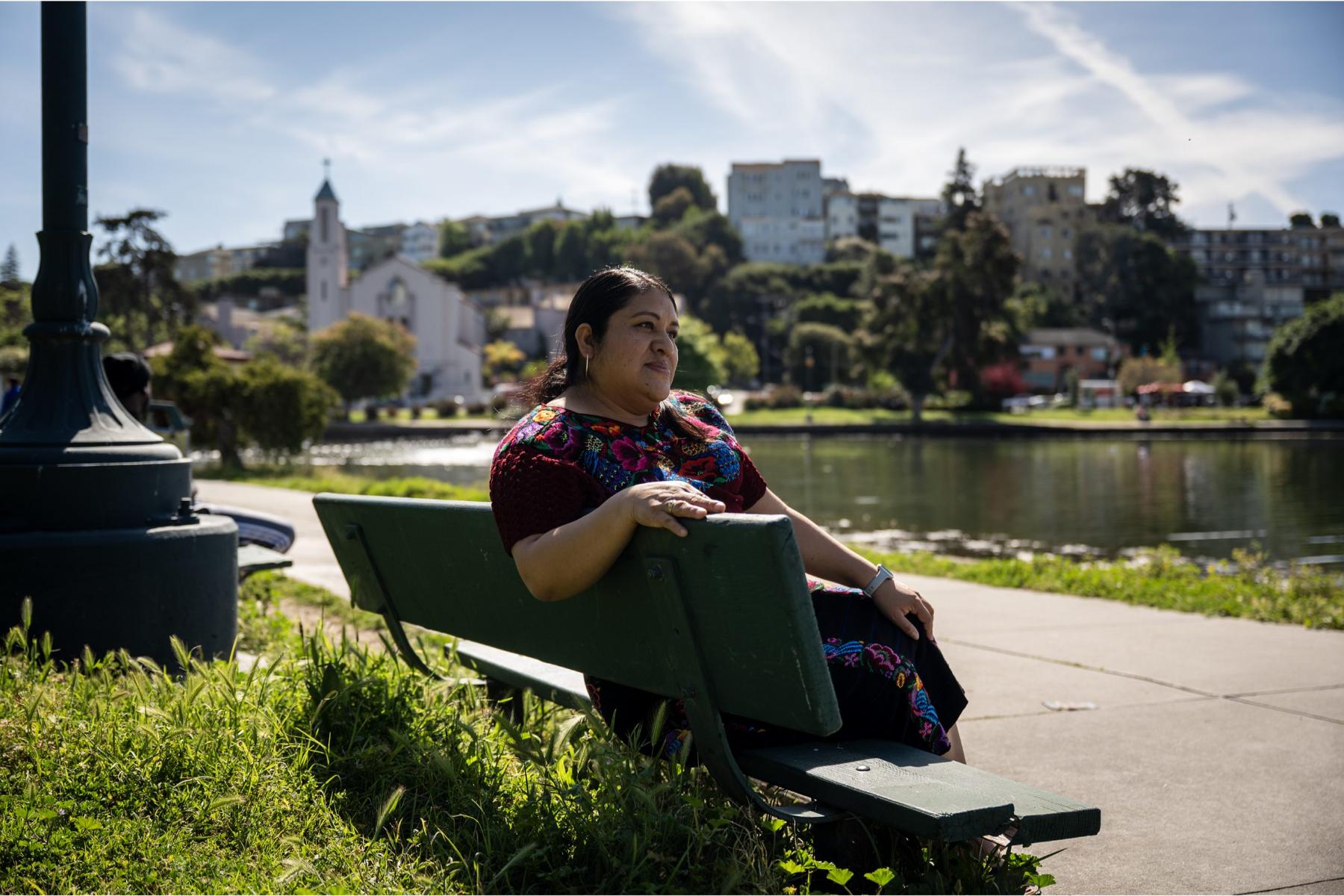 Woman sitting on a bench at Lake Merritt in Oakland, California