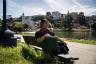 Woman sitting on a bench at Lake Merritt in Oakland, California