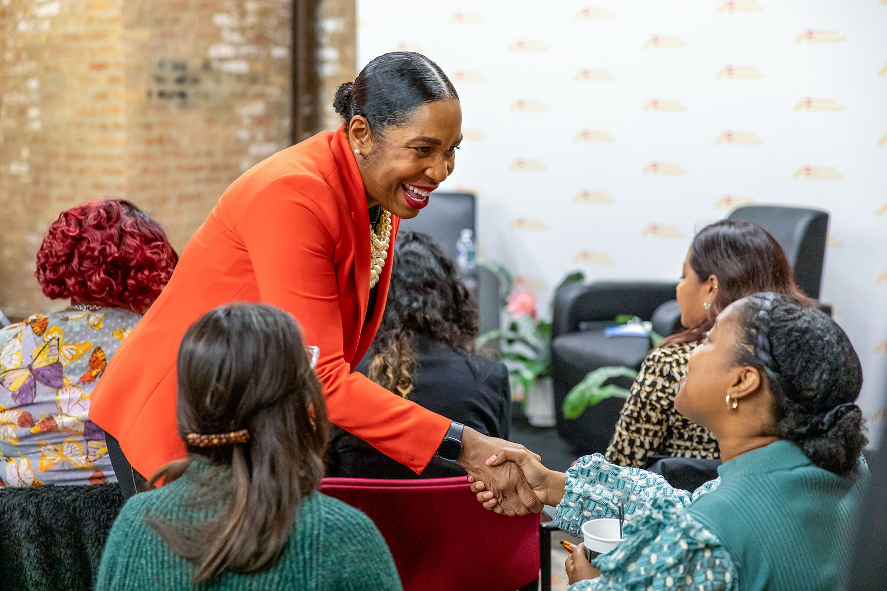 Lt. Gov. Juliana Stratton smiles while shaking hands with an attendee at a WeChat event in Chicago.
