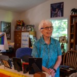 Rev. Heyward Carter sits at a desk on her computer.