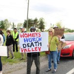 People hold signs at a protest outside of the Women's Huron Valley Correctional Facility in Washtenaw County, Michigan.