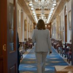 Sarah McBride walks away down a long hallway.