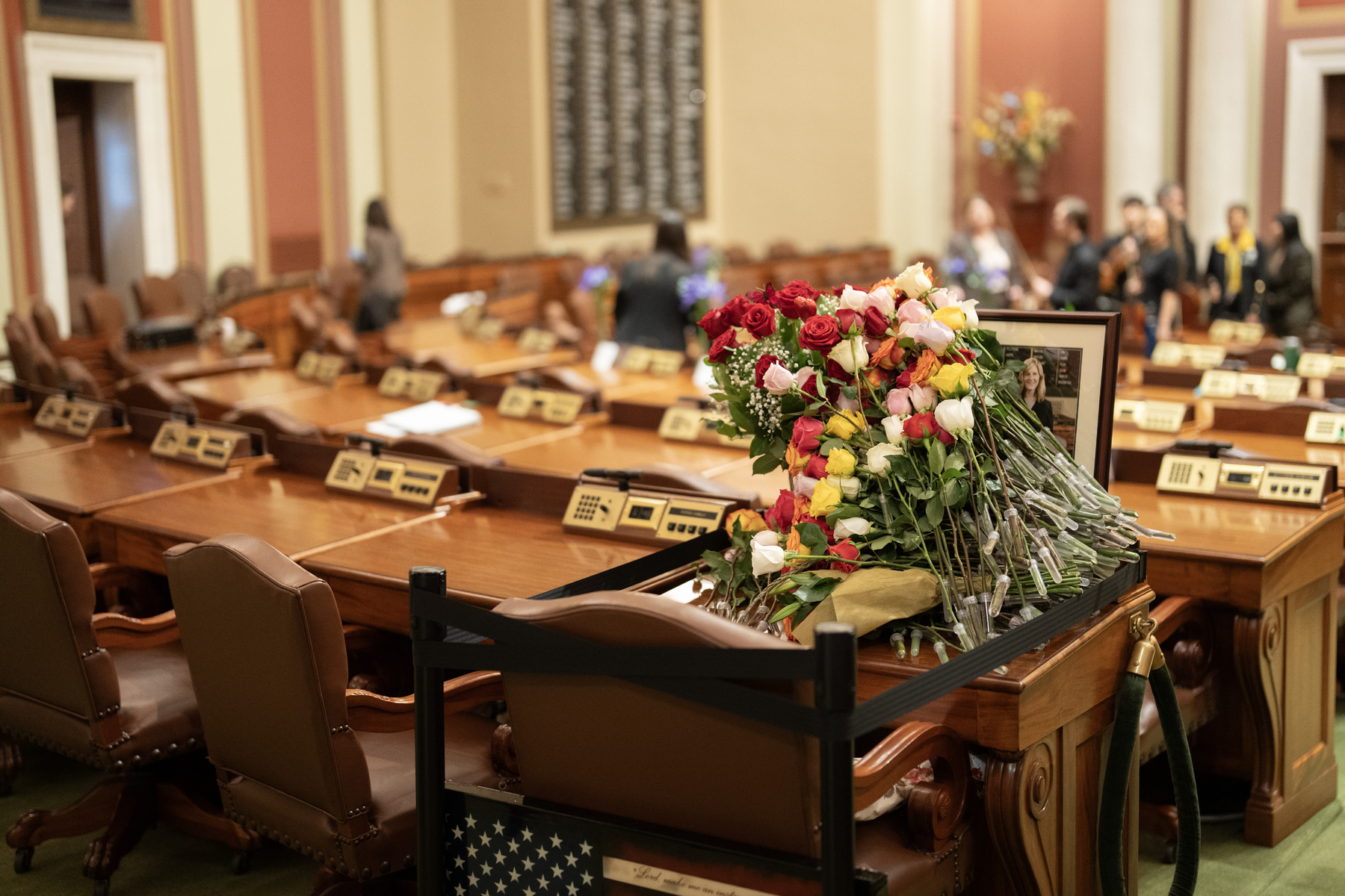 Dozens of roses remain on the desk of the late Rep. Melissa Hortman
