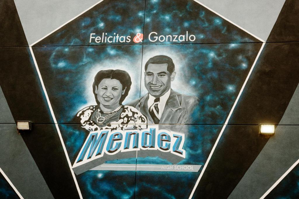 A mural honoring Felicitas and Gonzalo Mendez with headshot images of them.
