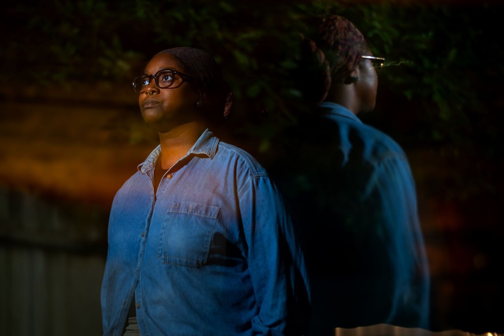 Mo Turner stands for a portrait image against a dark background.