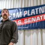 U.S. Senate candidate Graham Platner speaks in front of a sign with his name on it