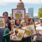 People hold signs that read 