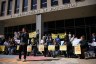 Demonstrators protest with signs outside of the U.S. Department of Education.