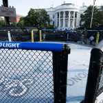 A UFC octagon with Bud Light advertisements on rails sits outside of the White House
