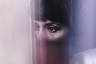 A woman's eyes in closeup looking off camera.