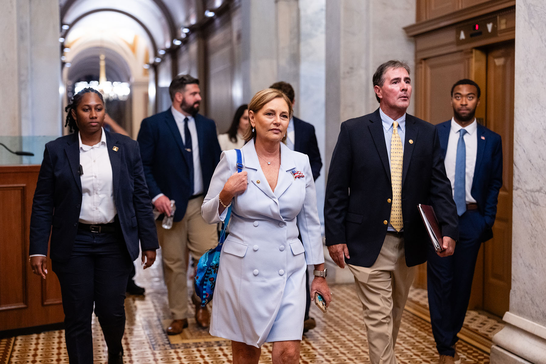 Sen. Darline Graham Nordone departs with staff and Capitol Police after being sworn in at the Capitol.