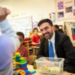 New York City Mayor Zohran Mamdani smiles and plays with children as he visits a child care center in the Bronx.