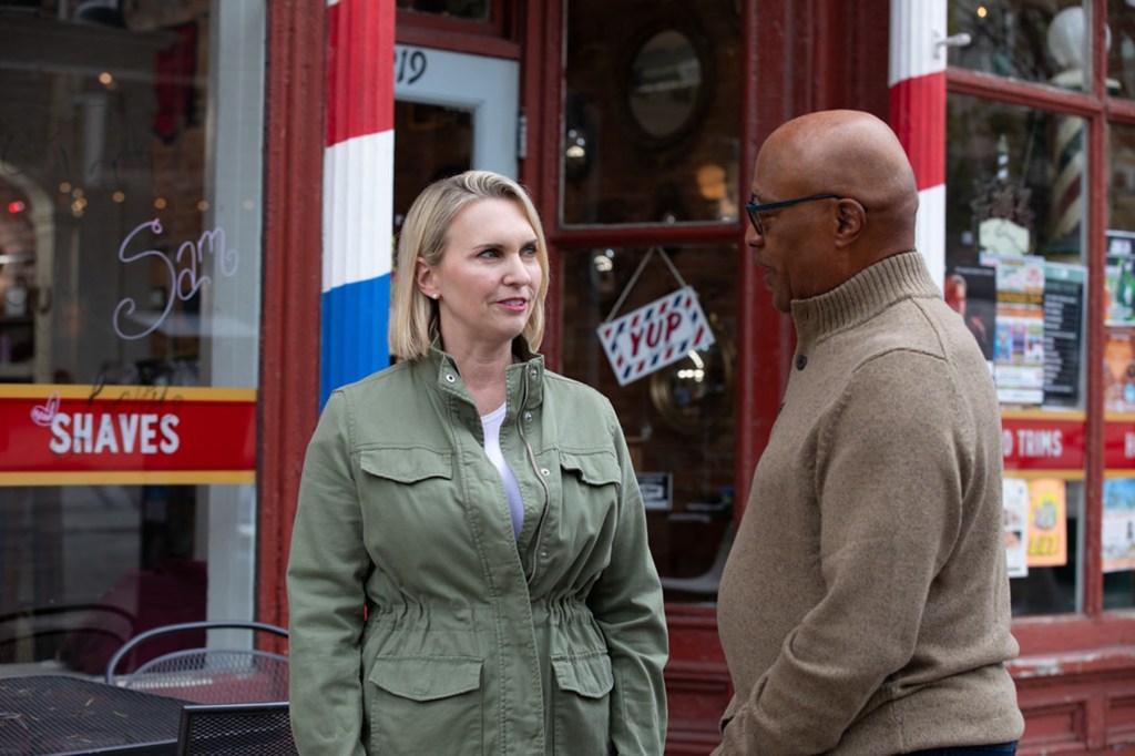 Democratic congressional candidate Bridget Brink speaks with a constituent outside a storefront.