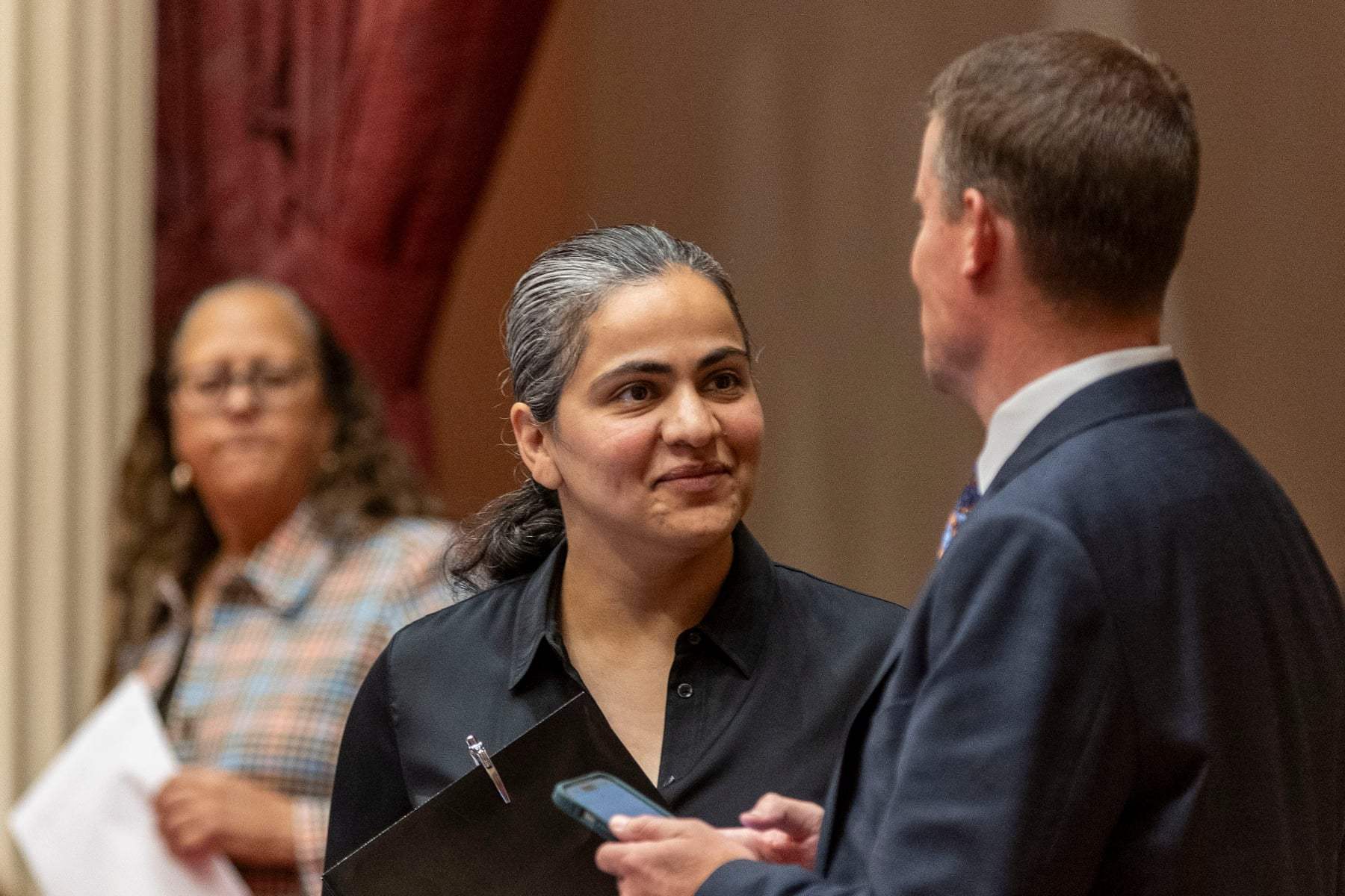 California state Sen. Aisha Wahab stands with a colleague at the state legislature in Sacramento on June 15, 2026.