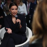 Alexandria Ocasio-Cortez, U.S. representative for New York's 14th congressional district, speaks into a microphone at an event.