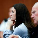Lindsay Clancy is seen in profile, sitting at her trial next to her defense attorney