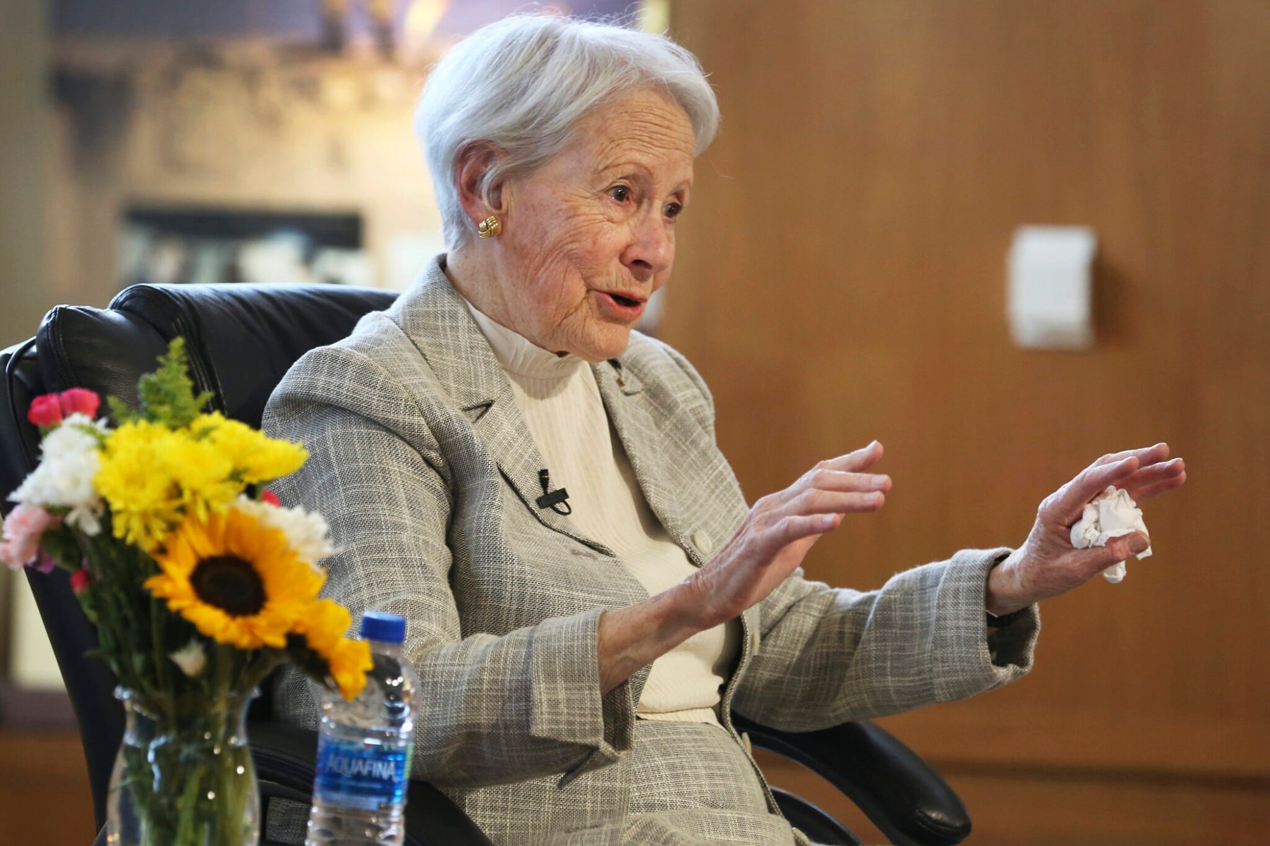 Kassebaum gestures while speaking and seated in a chair.