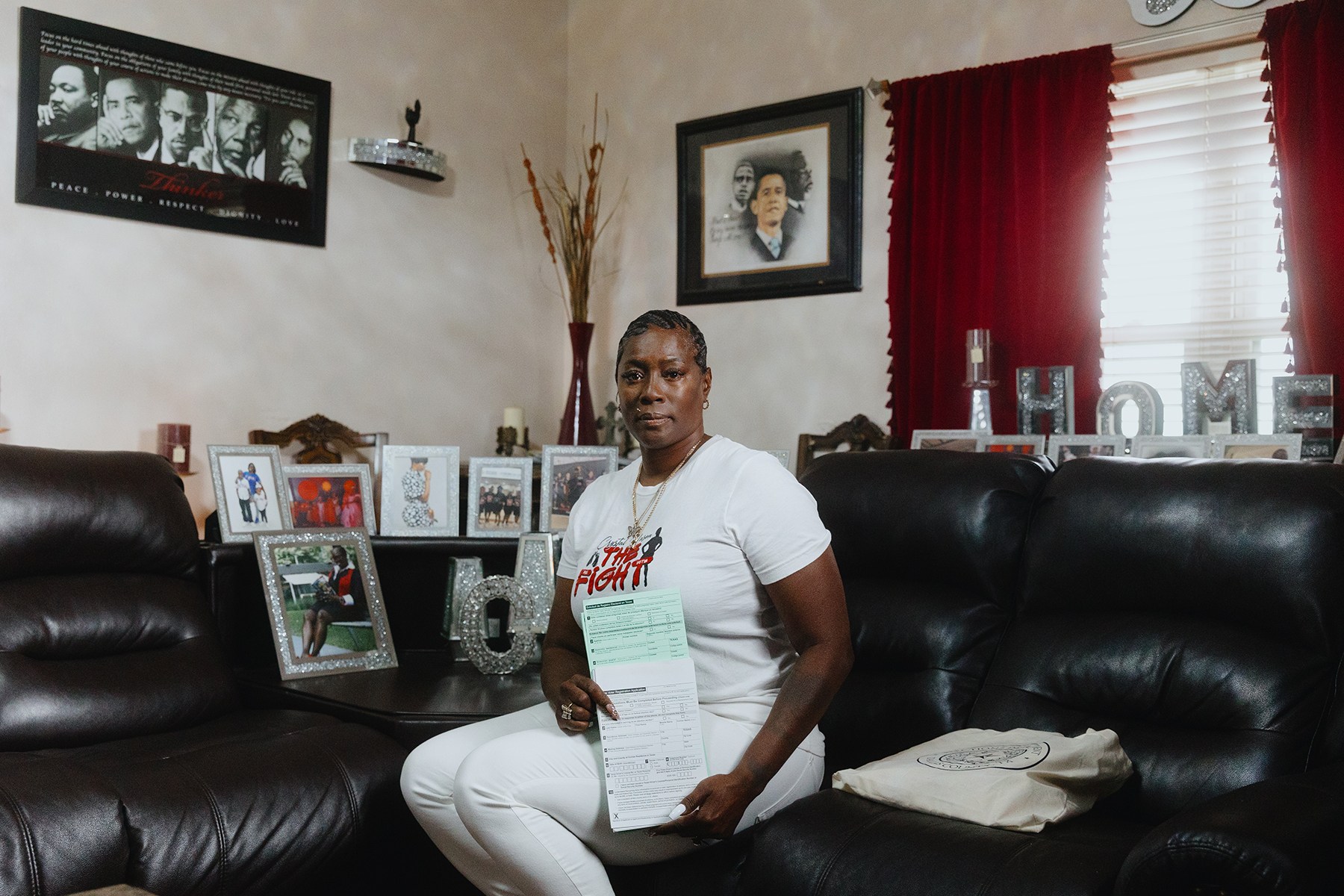Crystal Mason holds Texas Voter Registration Application forms in her home in Fort Worth